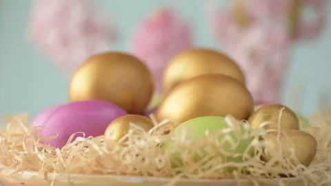 Easter eggs in straw spin on blue background Stock Footage 148287448