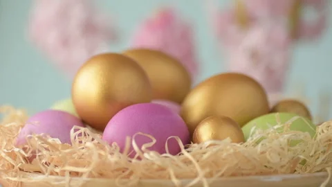 Easter eggs in straw spin on blue background Stock Footage 148287453