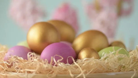 Easter eggs in straw spin on blue background Stock Footage 148287487