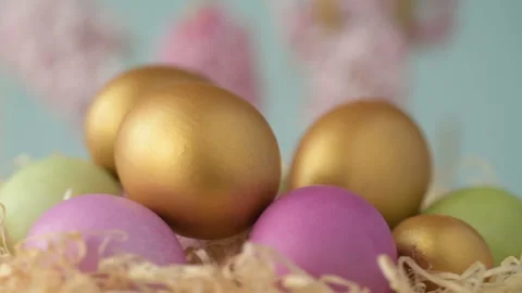 Easter eggs in straw spin on blue background Stock Footage 148287501