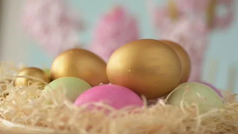 Easter eggs in straw spin on blue background Stock Footage 148287541