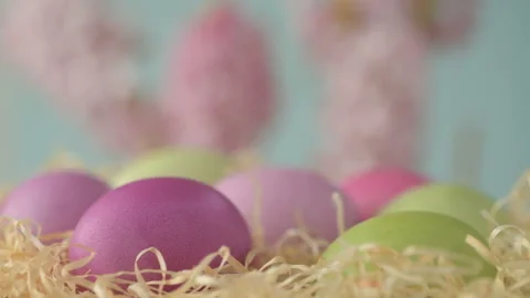 Easter eggs in straw spin on blue background Stock Footage 148287568