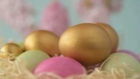 Easter eggs in straw spin on blue background Stock Footage 148287587
