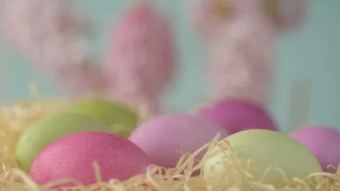 Easter eggs in straw spin on blue background Stock Footage 148287599