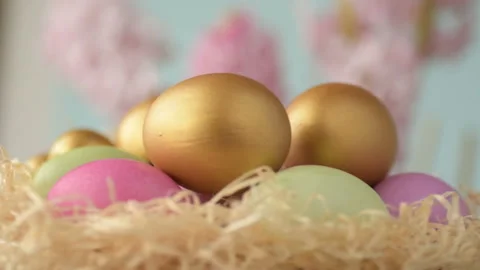 Easter eggs in straw spin on blue background Stock Footage 148287604