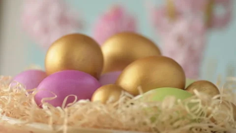 Easter eggs in straw spin on blue background Stock Footage 148287623