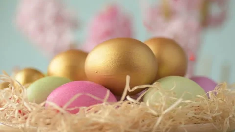 Easter eggs in straw spin on blue background Stock Footage 148287652