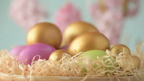 Easter eggs in straw spin on blue background Stock Footage 148287656