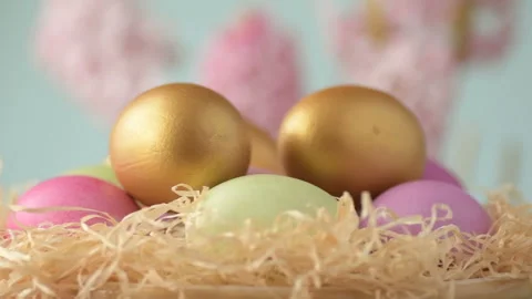Easter eggs in straw spin on blue background Stock Footage 148287672