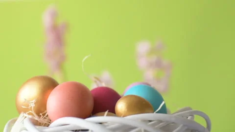 Easter eggs in straw spin on green background Stock Footage 148287645
