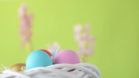 Easter eggs in straw spin on green background Stock Footage 148287669
