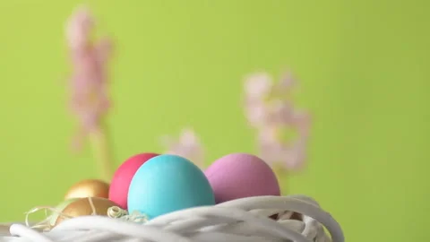 Easter eggs in straw spin on green background Stock Footage 148287674