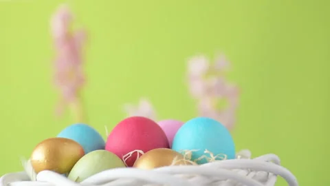 Easter eggs in straw spin on green background Stock Footage 148287719