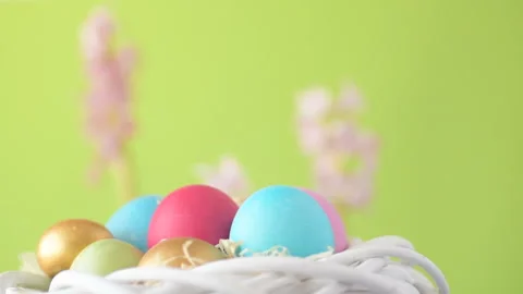 Easter eggs in straw spin on green background Stock Footage 148287720