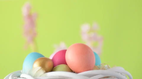 Easter eggs in straw spin on green background Stock Footage 148287723