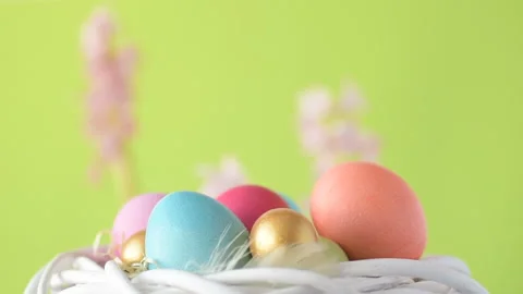 Easter eggs in straw spin on green background Stock Footage 148287725