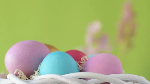 Easter eggs in straw spin on green background Stock Footage 148287773