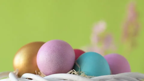Easter eggs in straw spin on green background Stock Footage 148287774