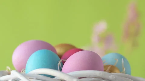 Easter eggs in straw spin on green background Stock Footage 148287775