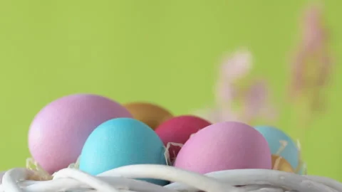 Easter eggs in straw spin on green background Stock Footage 148287776