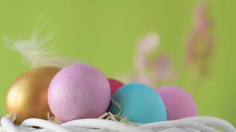 Easter eggs in straw spin on green background Stock Footage 148287806