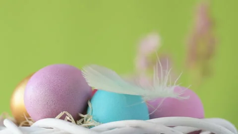 Easter eggs in straw spin on green background Stock Footage 148287830