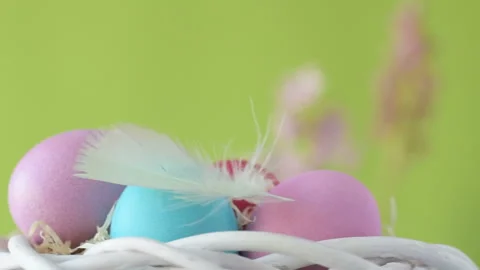 Easter eggs in straw spin on green background Stock Footage 148287834