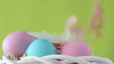 Easter eggs in straw spin on green background Stock Footage 148287856