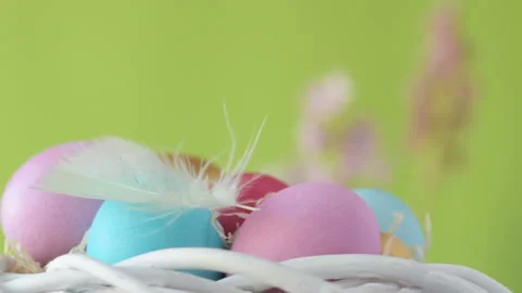Easter eggs in straw spin on green background Stock Footage 148289059