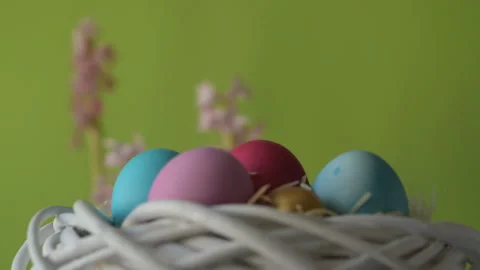 Easter eggs in straw spin on green background Stock Footage 148289295