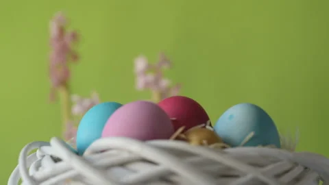 Easter eggs in straw spin on green background Stock Footage 148289352