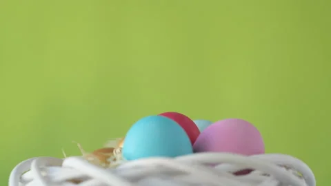 Easter eggs in straw spin on green background Stock Footage 148289824