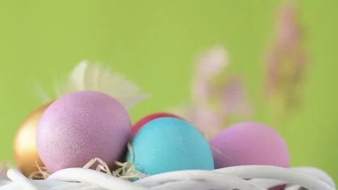 Easter eggs in straw spin on green background Stock Footage 148290304