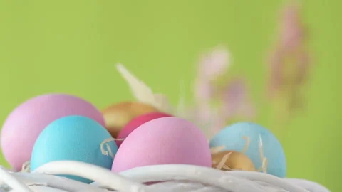 Easter eggs in straw spin on green background. Stock Footage 148290319