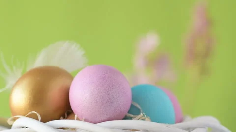 Easter eggs in straw spin on green background. Stock Footage 148290329