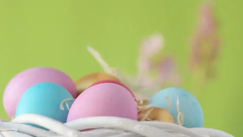 Easter eggs in straw spin on green background Stock Footage 148290913