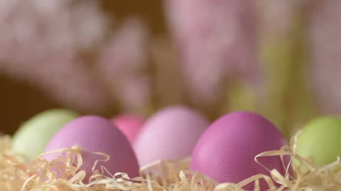 Easter eggs in straw spin on yellow background Video stock 148287481