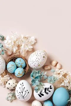 Easter eggs with sweets and flowers on beige. Happy Easter concept. White a.. Stock Photos