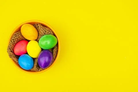Easter Eggs in Thread-Filled Bowl Over Yellow Surface Stock Photos