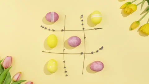 Easter Eggs Tic Tac Toe Stop Motion on Yellow Background 4K Video stock 330532171
