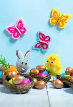 Easter eggs with a toy easter rabbit and chick Stock Photos