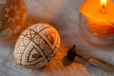 Easter eggs with traditional geometric pattern, a waxing tool and burning can Stock Photos