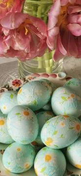 Easter eggs with tulips on the festive table Stock Photos