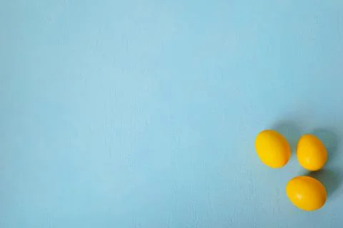 Easter eggs on a turquoise background. Minimal Easter concept Stock Photos