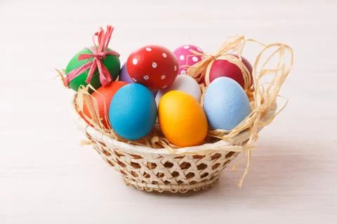 Easter eggs in a weaved basket Stock Photos