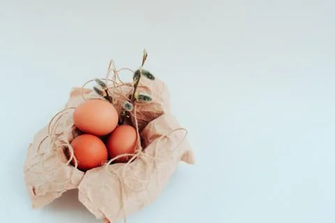 Easter eggs on a white background with a sprig of willow Foto stock