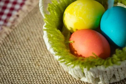 Easter eggs in a white basket. Stock Photos