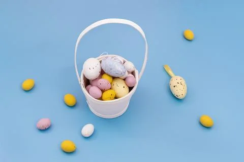 Easter eggs in white basket Stock Photos