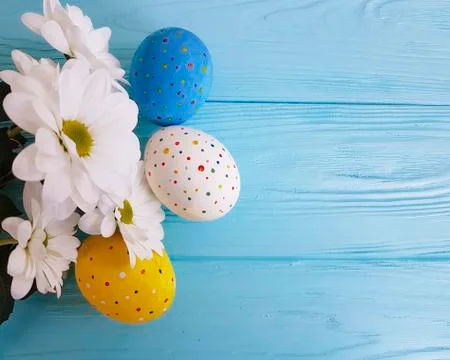 Easter eggs white flowers blue wood Stock Photos