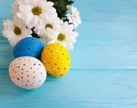 Easter eggs white flowers blue wood Stock Photos